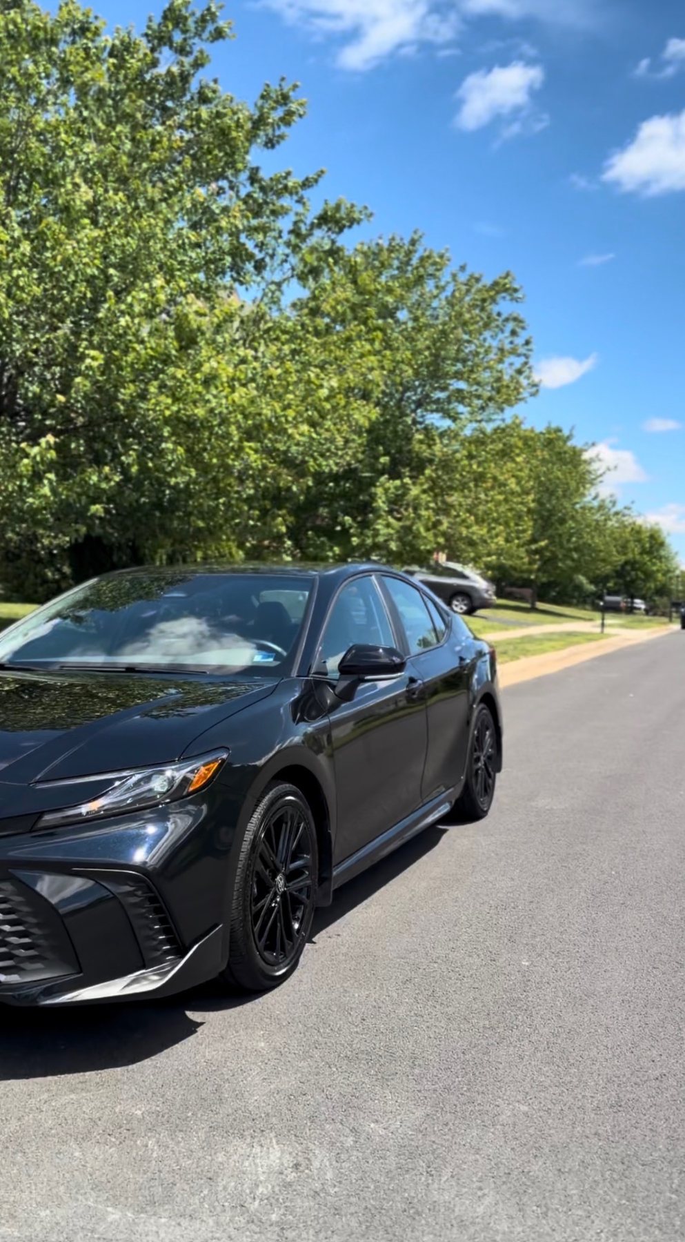 Clean black sedan after exterior wash